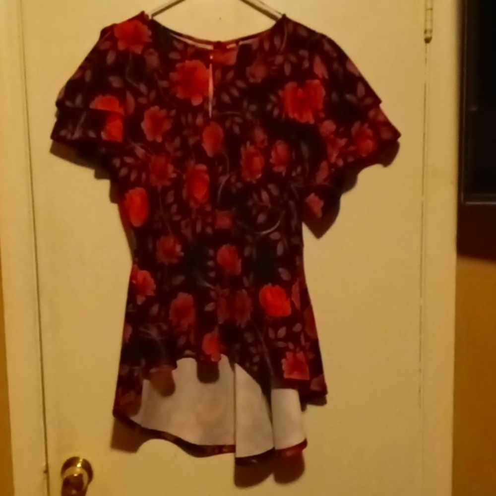 This is a blouse with many different colors red pink hot pink light pink black